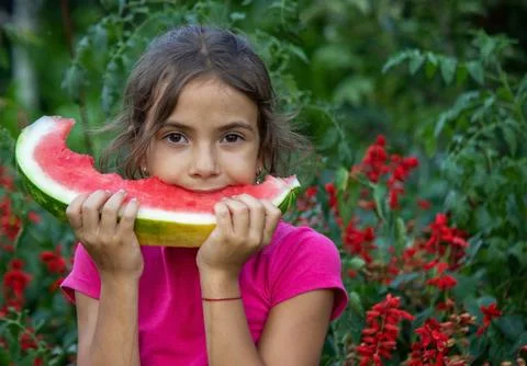 A child eats a watermelon. Selective focus. Stock Photos