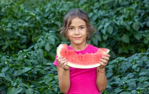 A child eats a watermelon. Selective focus. Stock Photos