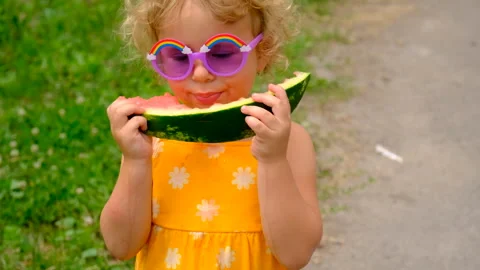 The child eats watermelon in summer. Selective focus. Stock Footage 245559401
