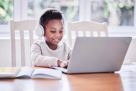 Child, elearning and laptop in home with headphones, tutorial video and learning Stock Photos