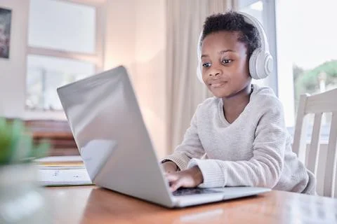 Child, elearning and laptop in house with headphones, tutorial video and skill Fotos Stock