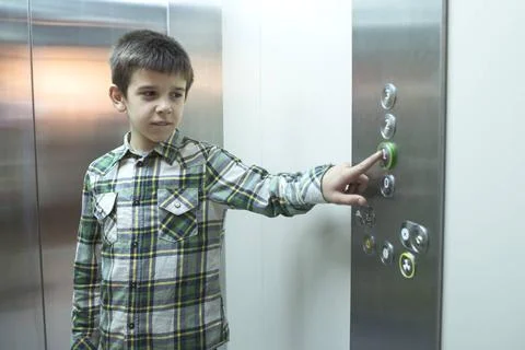 Child in an elevator Child pushed a button in an elevator. ,model released... Foto stock