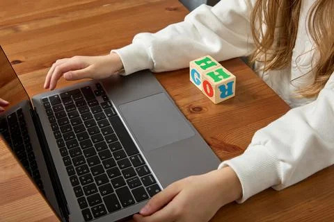Child is engaged in a computer online learning the English alphabet Stock Photos