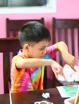 Child Engaged in Creative Art Activity with Bright Colors Stock Photos