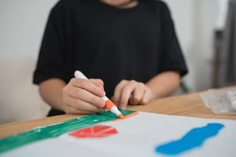Child Engaged in Creative Art Activity with Colorful Markers and Paper at H.. Stock Photos
