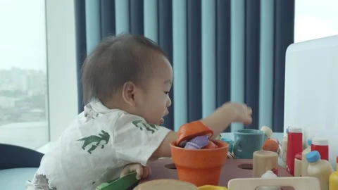 Child Engaged in Creative Play with Colorful Toys Vidéo 343556587
