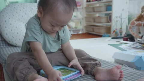 Child Engaged with Educational Device in Cozy Learning Environment Vidéo 343556746