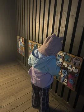 Child Engaged with Interactive Activity Wall Stock Photos