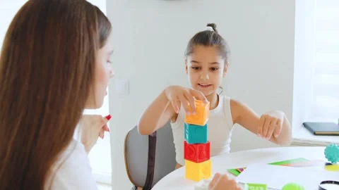 Child engaged in interactive speech therapy session with therapist using Stock Footage 315538082