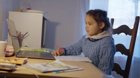 A Child Engaged in Online Learning While Comfortably at Home and Staying Focused Stock Footage 305459776