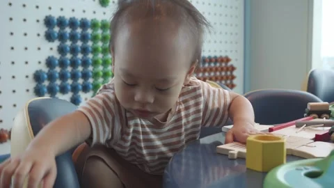 Child Engaged in Playful Learning Activities in Brightly Colored Environment Stock Footage 343556219