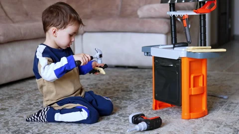 Child engaged in pretend play with tools 스톡 동영상 309699103