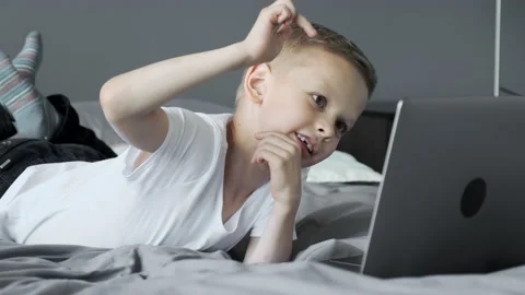 The Child Is Engaged In Using a Laptop, Playing Games at the Computer Video stock 157814913