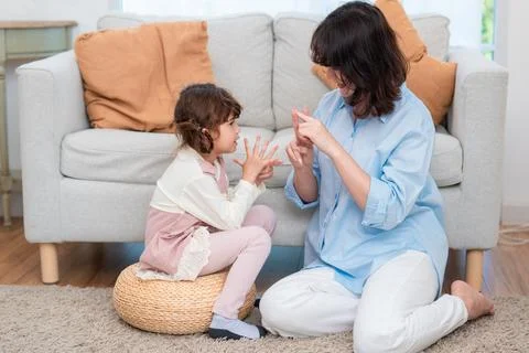 Child engages in a hands-on learning activity at home with a parent while s.. Stock-Fotos