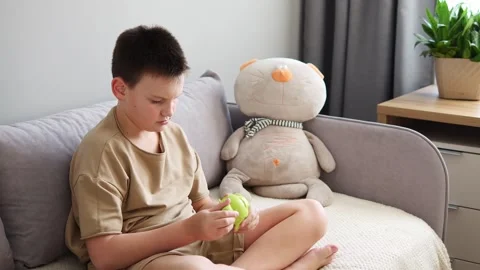 Child engrossed in solving puzzle on sofa. Captivating scene of intellectual Stock Footage 268567669