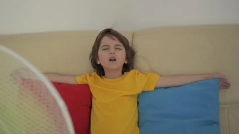 Child Enjoying Cool Wind From Electric Fan at Home at Summer Heat Weather. .. Stockbeeldmateriaal 343588695