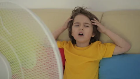 Child Enjoying Cool Wind From Electric Fan at Home at Summer Heat Weather. .. Video stock 343589026