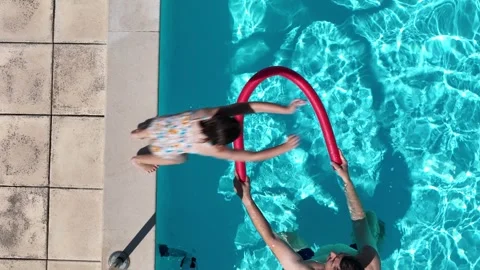Child Enjoying Summer Afternoon While Watching Adult Swim With Pool Floats Stock Footage 280994934