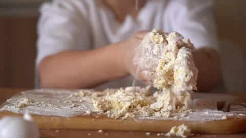 Child enjoys making dough from scratch in home kitchen Stock Footage 314655226
