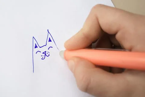 Child erasing drawing with erasable pen on paper sheet against beige backgr.. Stock Photos