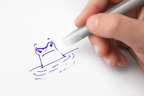Child erasing drawing with erasable pen on paper sheet, closeup Stock Photos