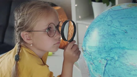 Child examines the globe Video stock 164908823