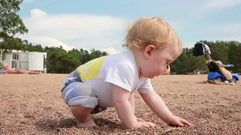 A child examines the sand Stock-Footage 135732981