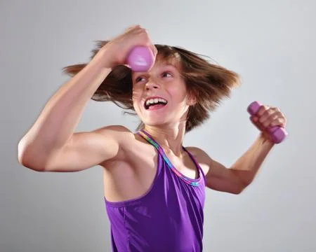 Child exercising with dumbells Stock Photos