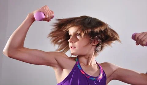 Child exercising with dumbells Stock Photos