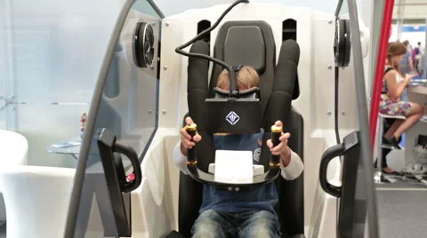 The child is experiencing a modern simulator Stock Footage 54643494