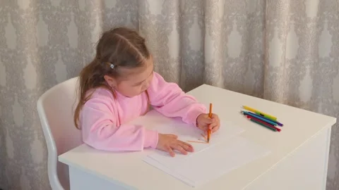 Child experiments with shapes and lines while drawing with colored pens Stock Footage 335942827