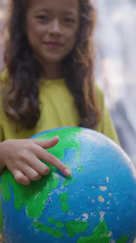 Child explores globe while discovering different countries and continents Stock Footage 293321964