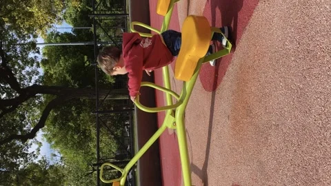 Child exploring and playing outdoors on the playground in the park. Stock Footage 254536231