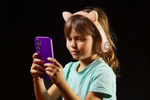 Child exploring digital sound through connected headphones Stock Photos