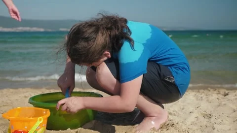 Child exploring green pool on sunny beach Stock Footage 336280126