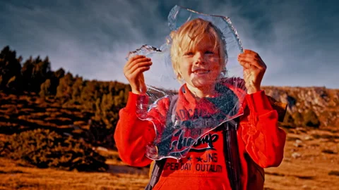 Child exploring the Pyrenees with ice in Spain during a sunny day Stock Footage 303631103