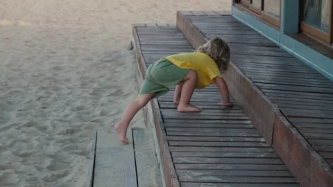 Child Exploring Steps at the Beach During Summer Stock Footage 311956069