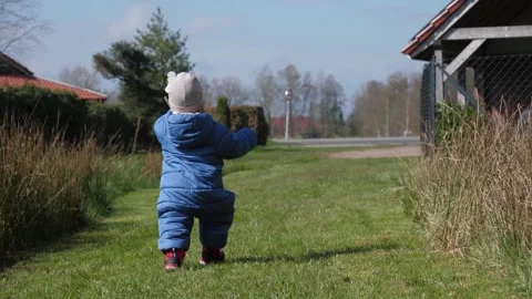 Child Exploring Yard Stock Footage 308538526
