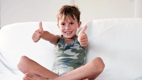 Child exulting on the sofa at home Stock Footage 138429967