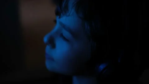 Child eye close-up tablet screen display. Monitor blue light is reflected in her Video stock 233959386