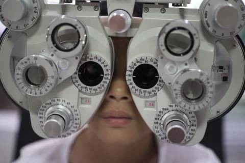 Child eye test in optical store 写真素材