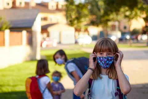 Child with face mask going back to school after covid-19 quarantine. Stock Photos