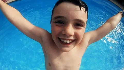 Child falling backwards in slow motion into a summer outdoor pool. Funny action Stock Footage 116622897