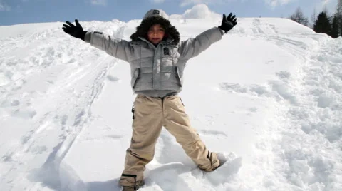 Child falling in the snow and draws angel Stock Footage 61876296
