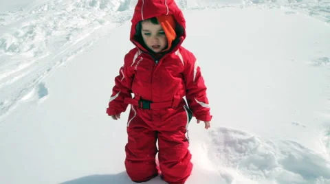 Child falling in the snow and draws angel Stock Footage 61876338
