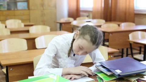 The child falls asleep in the classroom at the table. Stock-Footage 107776114