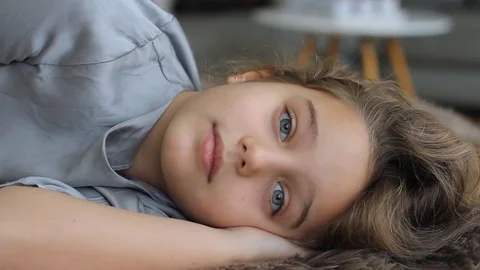 The child falls asleep, dozing, closes his eyes. Amazingly beautiful girl. Stock Footage 70029074