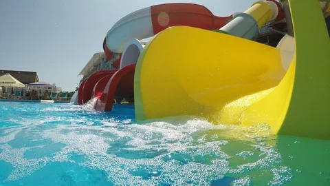 Child falls in the pool from the water slide , underwater view, slow motion 3 Stock Footage 94576384