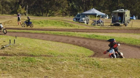 Child Falls While Racing Dirt Bike on Outdoor Track Stock Footage 316672793