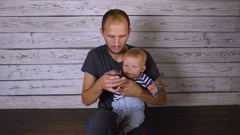 Child with father with phone Video stock 80273567